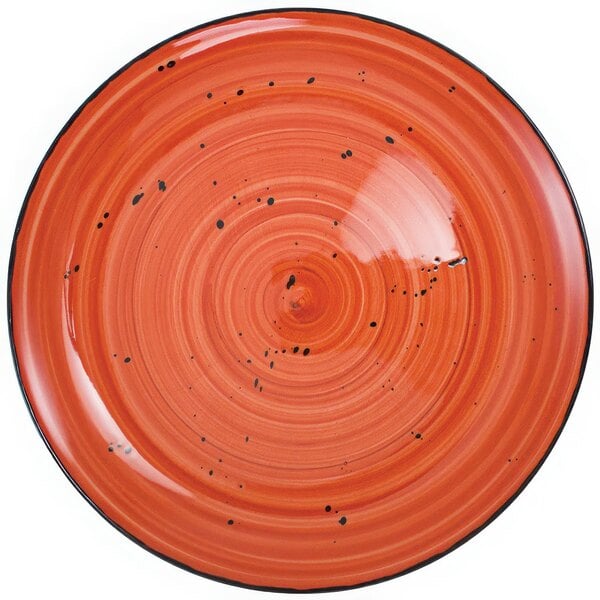 An International Tableware Ruby Coupe porcelain plate with black specks.