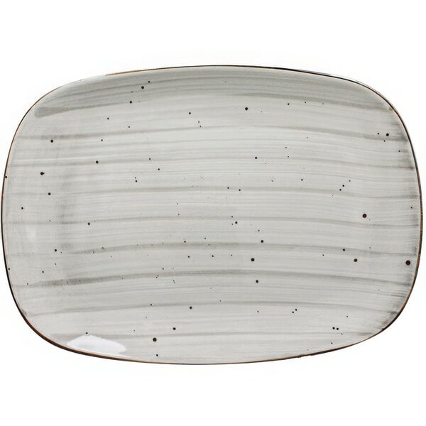 A white rectangular porcelain platter with black specks on it.