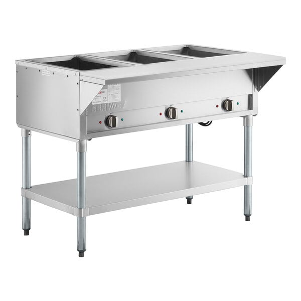 A stainless steel three pan open well electric steam table with adjustable undershelf.