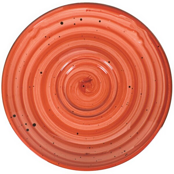 A red porcelain saucer with a spiral pattern on the surface.