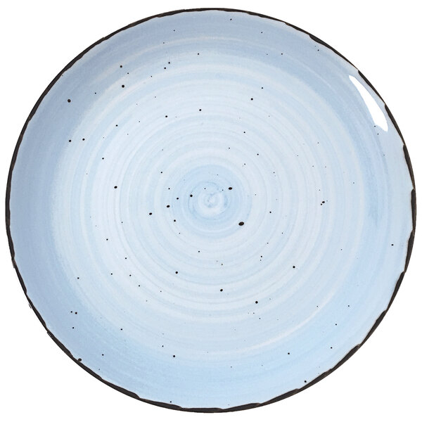 A white International Tableware porcelain plate with black dots on it.