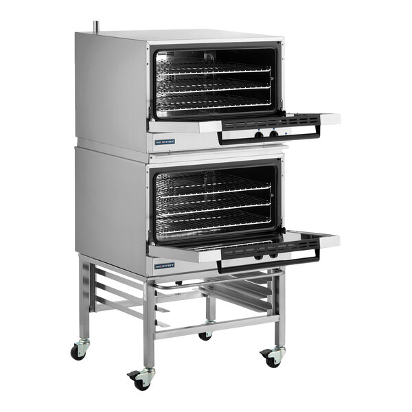 A double deck full size electric convection oven with mechanical controls and casters.
