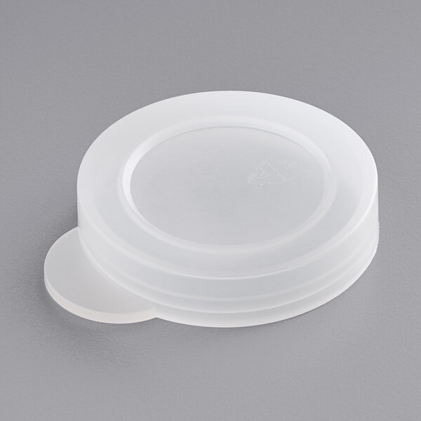 A white plastic round lid with a stack of American Metalcraft round plastic milk bottle lids.