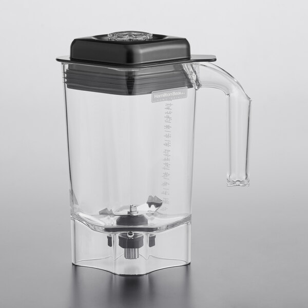 A clear Hamilton Beach blender jar with a black lid and blade.