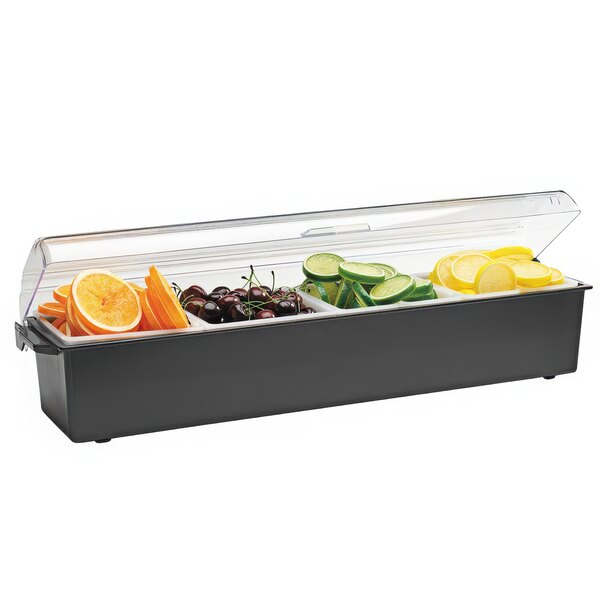 A Vollrath black plastic condiment bar with 4 compartments holding fruit and vegetables.