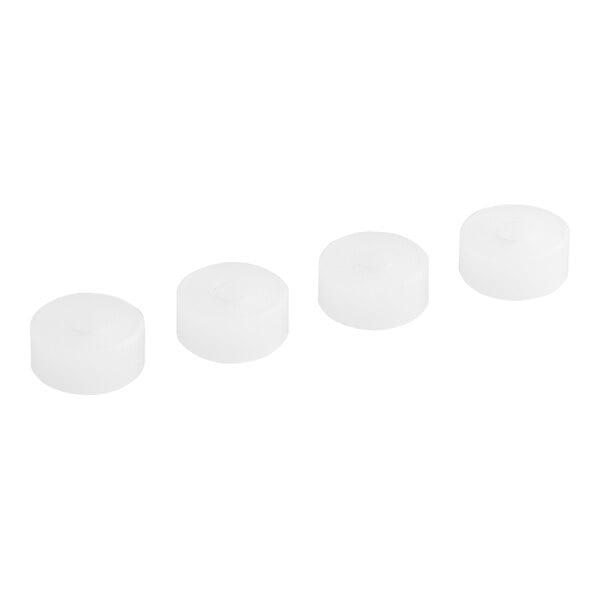 A row of white round plastic caps with a black circle on top.