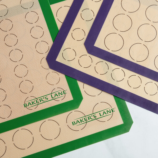 A Baker's Lane green silicone mat with circles for 64 macarons.