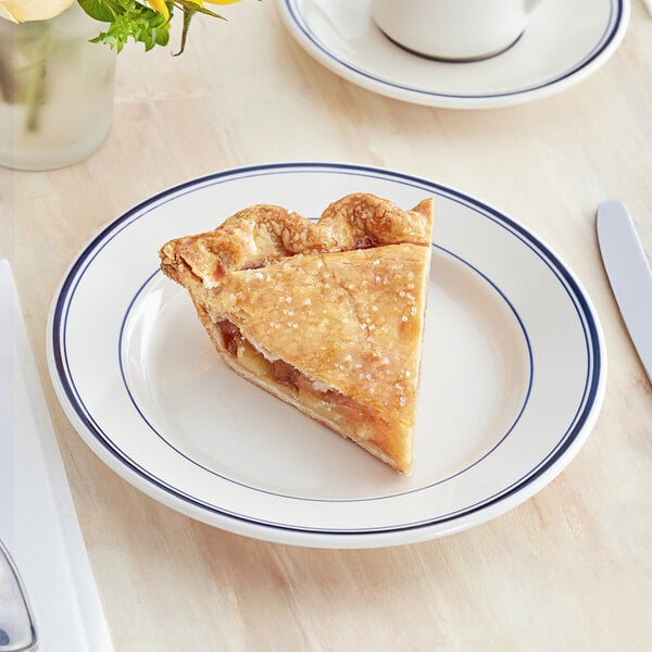 An Acopa ivory stoneware plate with blue bands holds a slice of pie.