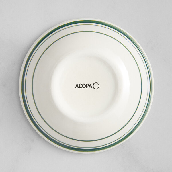 An Acopa ivory stoneware fruit dish with green stripes on it.