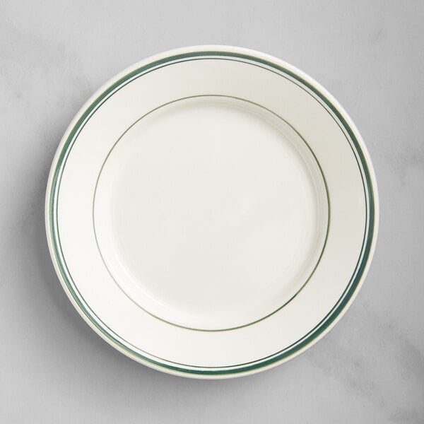 An Acopa ivory stoneware plate with wide rims and green bands.