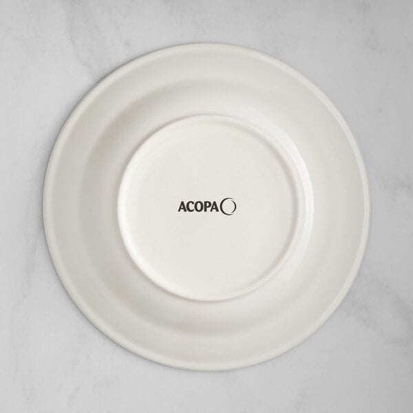 An ivory stoneware pasta bowl with green bands and black text that reads "Acopa"