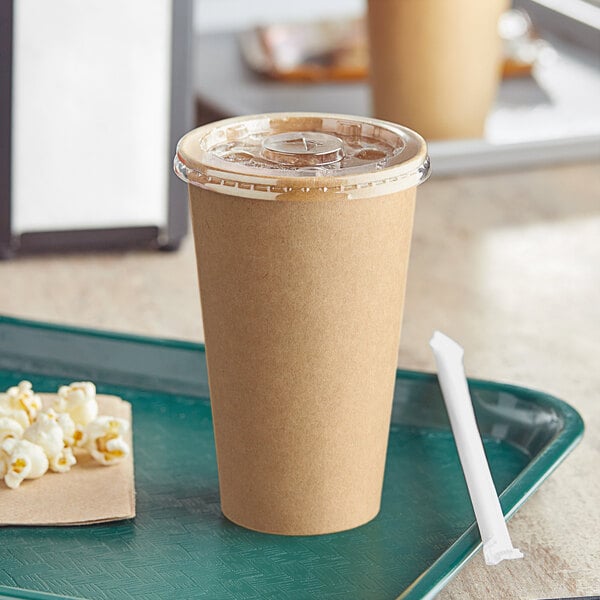 A tray with a brown Economy Kraft paper cup filled with soda and popcorn.