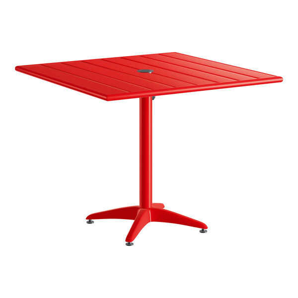 A square red powder-coated aluminum outdoor dining table with an umbrella hole and a four-legged base.