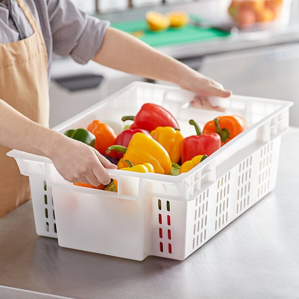 white produce crate filled with colorful bell peppers