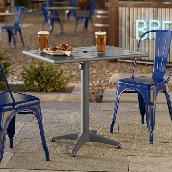 A rectangular gray powder-coated aluminum outdoor dining table with an umbrella hole.