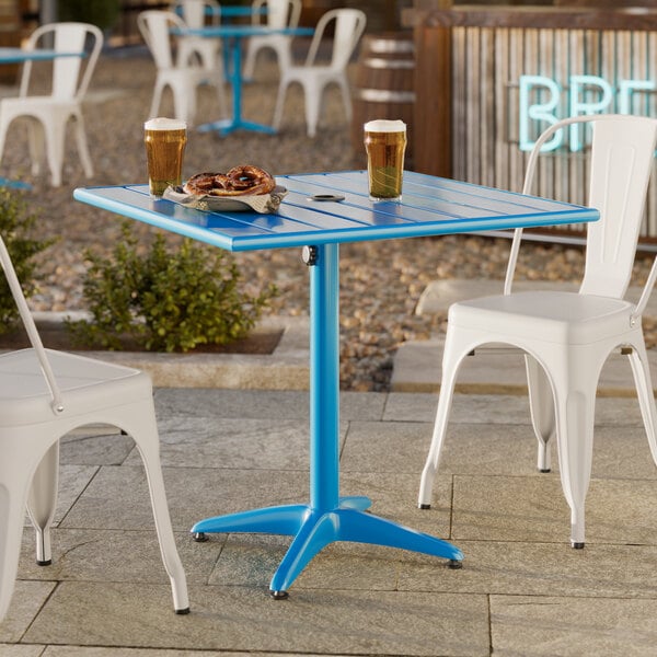 A blue powder-coated aluminum outdoor dining table with a square 32-inch top and an umbrella hole.