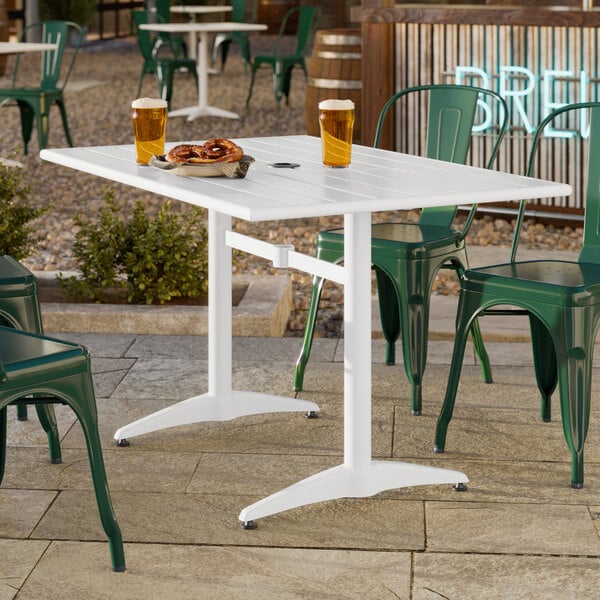 A rectangular white powder-coated aluminum outdoor dining table with an umbrella hole.