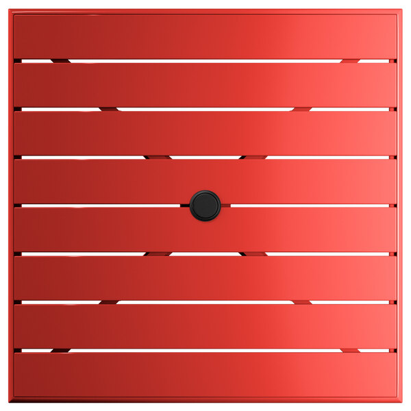 A red square Lancaster Table & Seating bar height outdoor table with a black umbrella hole in the middle.