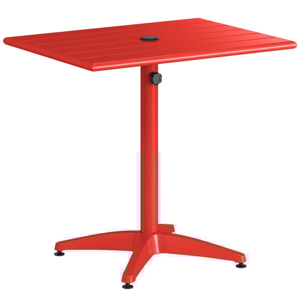 A red Lancaster Table & Seating aluminum dining height table with a black umbrella hole cover.