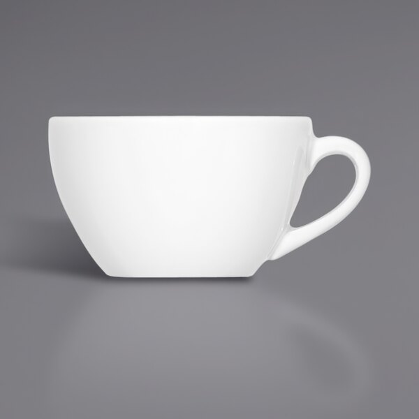A close-up of a Bauscher by BauscherHepp white porcelain espresso cup with a handle.