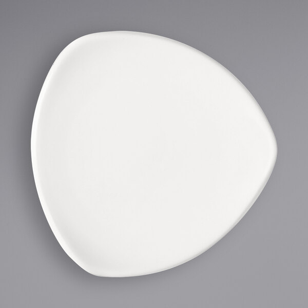 A Bauscher bright white porcelain triangular plate with a circular design on it.