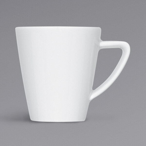 A close-up of a Bauscher bright white porcelain espresso cup with a handle.