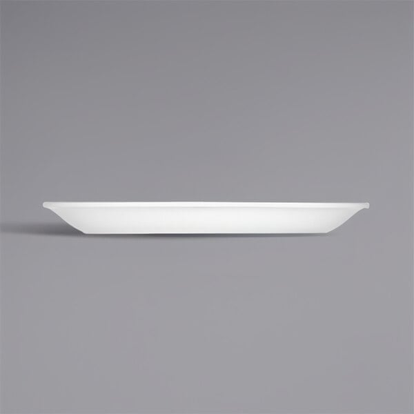 A white oval porcelain platter with a grey background.