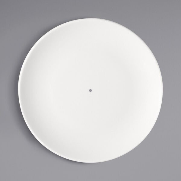 A Bauscher bright white porcelain coupe etagere plate with a hole in the middle.