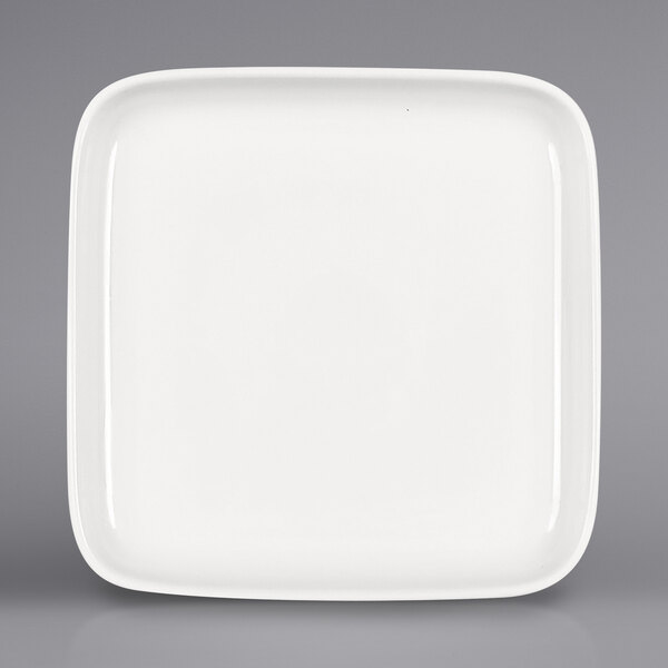 A Bauscher bright white square porcelain plate with a raised rim.