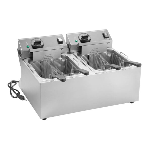 A Vollrath commercial countertop deep fryer with two twin pots and two baskets.