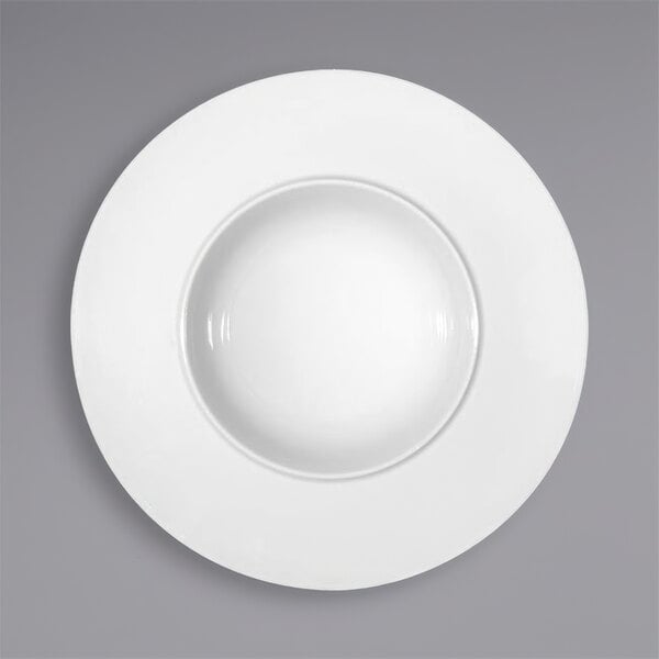 A Bauscher by BauscherHepp white porcelain deep plate with a wide rim.