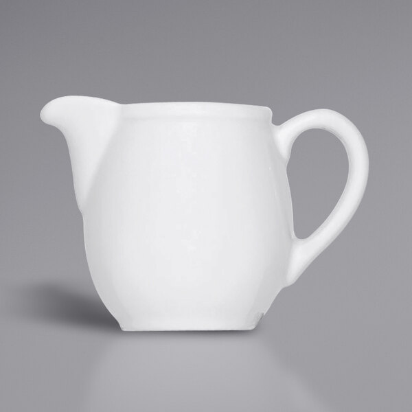 A Bauscher bright white porcelain creamer with a handle.