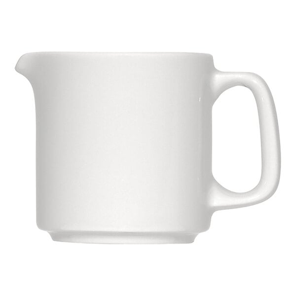 A plain white porcelain creamer with a handle and a small spout.