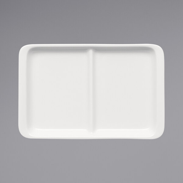 a white rectangular plate with two compartments