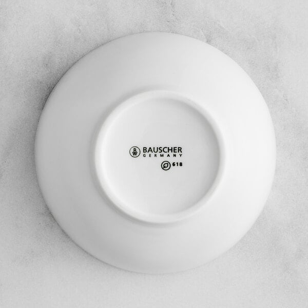 A white Bauscher porcelain teacup with black text that reads "Bauscher"