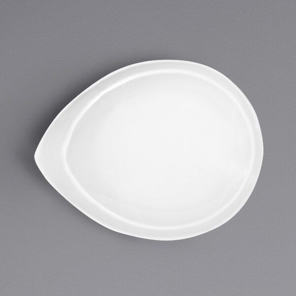 A Bauscher bright white porcelain teardrop bowl on a gray surface.