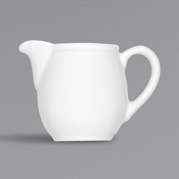 A white pitcher with a handle.