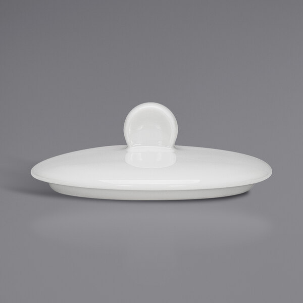 A Bauscher bright white porcelain sugar bowl lid with the lid open.