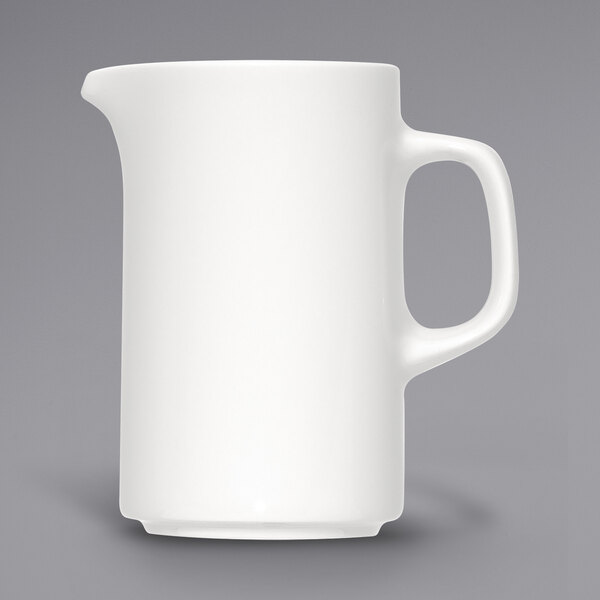 A Bauscher bright white porcelain creamer with a handle.