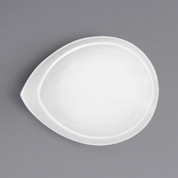A bright white porcelain teardrop bowl with a white background.