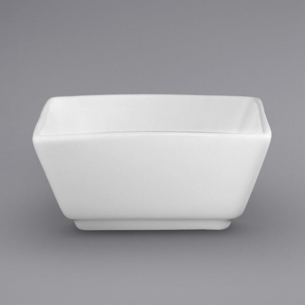 A close up of a white square International Tableware ramekin.