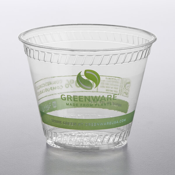 A clear plastic Fabri-Kal cold cup with a green Greenware logo.