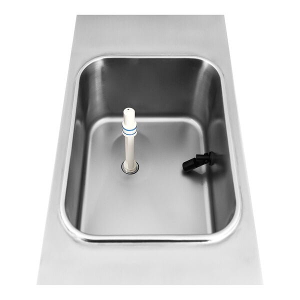 A stainless steel countertop soft serve ice cream machine hopper with a central mixing spindle and a side spout.