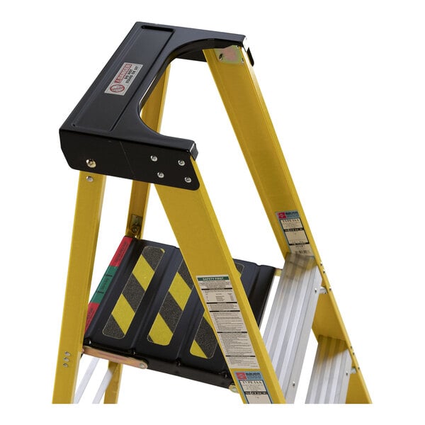 A yellow Bauer step ladder with black and yellow stripes.