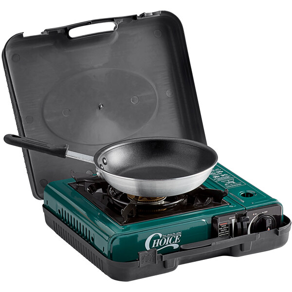 A Choice portable brass burner stove with a pan on top.