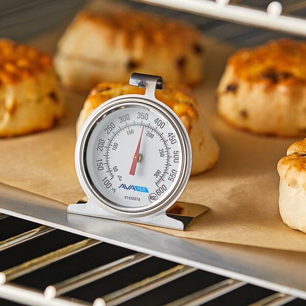 An AvaTemp oven thermometer in a tray of baked goods.
