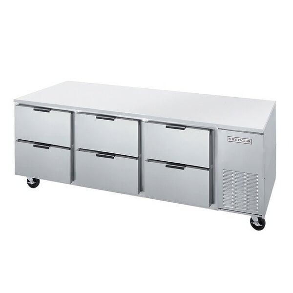 A white undercounter refrigerator with 6 drawers.