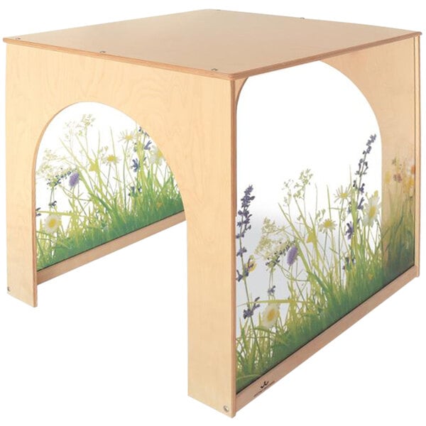 A wooden table with a picture of grass and flowers on it.