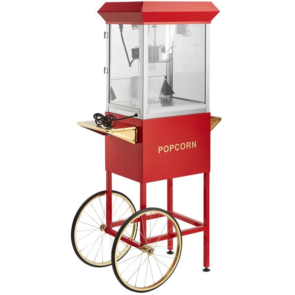 A red and gold Carnival King 8 oz. popcorn machine on a stand with wheels.