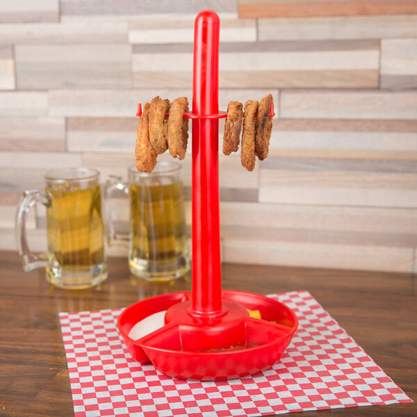 A red polypropylene server with food on it and a red handle.